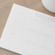a weekly lifestyle planner on wood side table