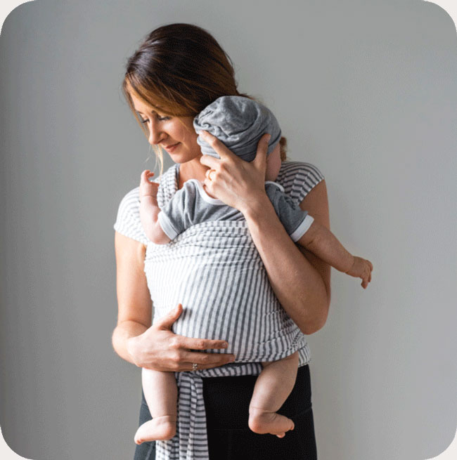woman holding baby and sustainable baby wrap