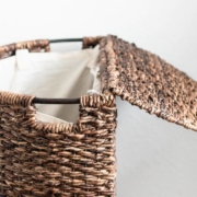 Brown laundry basket against white wall